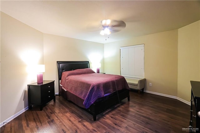 bedroom with dark hardwood / wood-style flooring and ceiling fan