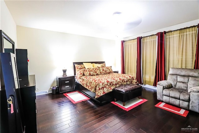 bedroom with ceiling fan and dark hardwood / wood-style flooring