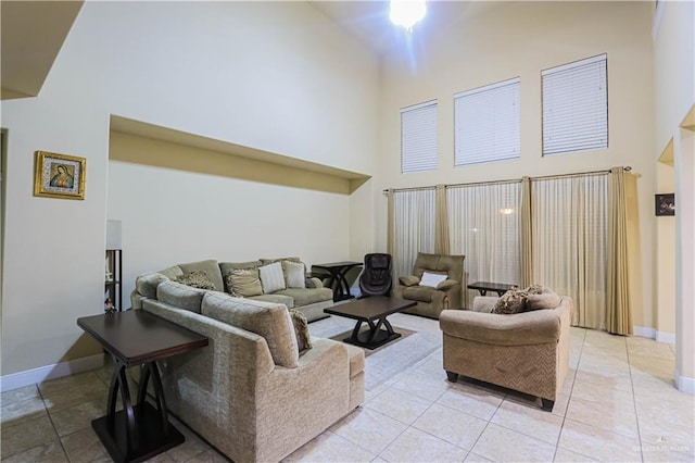 living room with light tile patterned floors and a high ceiling