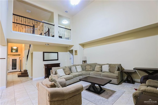 tiled living room featuring high vaulted ceiling