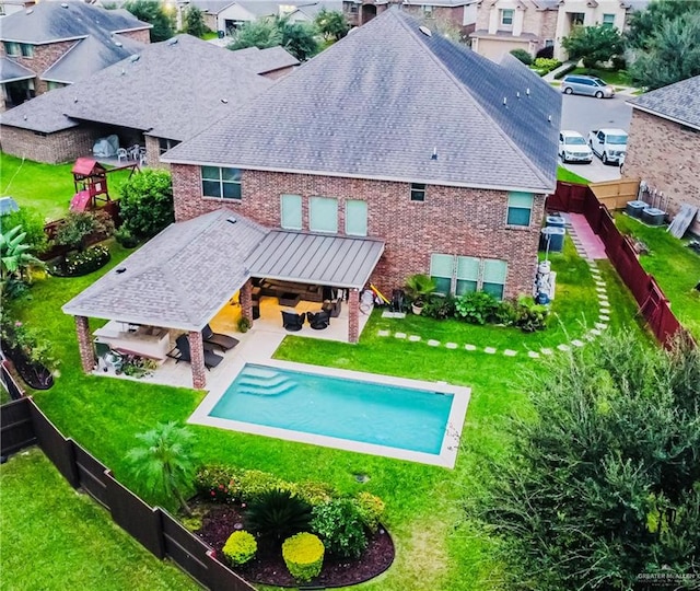 back of house with a lawn, an outdoor hangout area, and a patio