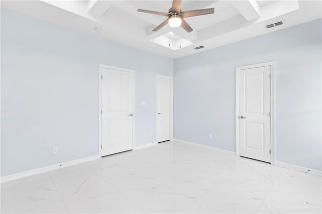 spare room featuring beam ceiling, a tray ceiling, and ceiling fan