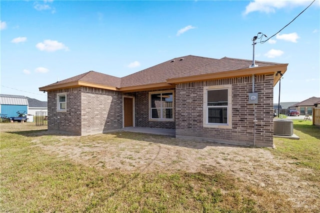 rear view of property with a lawn and central AC unit