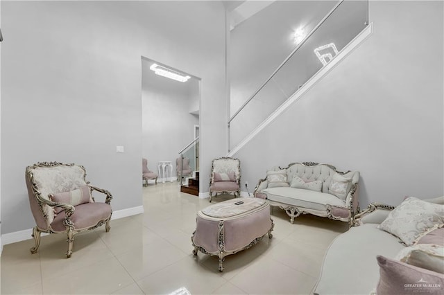 sitting room featuring light tile patterned flooring and a towering ceiling