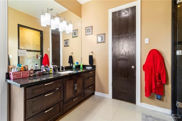 bathroom with walk in shower, tile patterned floors, and vanity