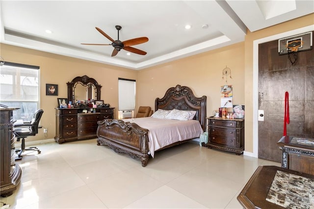 bedroom with a raised ceiling, light tile patterned floors, and ceiling fan