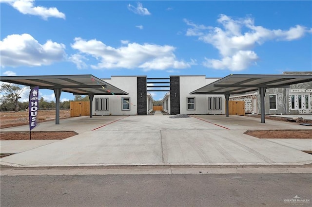 exterior space with a carport and stucco siding