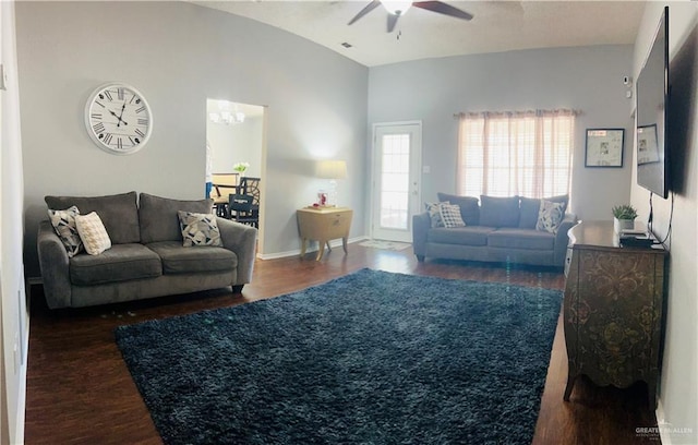 living room with ceiling fan and dark wood-type flooring