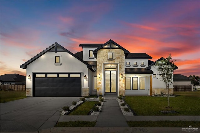 view of front of house with a garage and a yard