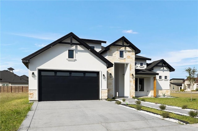 view of front of property featuring a garage and a front yard