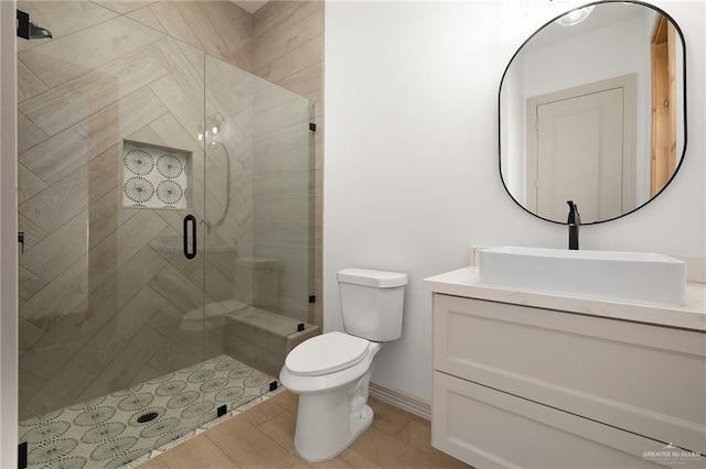 bathroom with vanity, toilet, and an enclosed shower