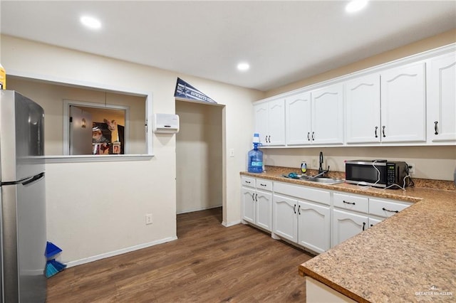 kitchen featuring white cabinets, stainless steel appliances, sink, and dark wood-type flooring