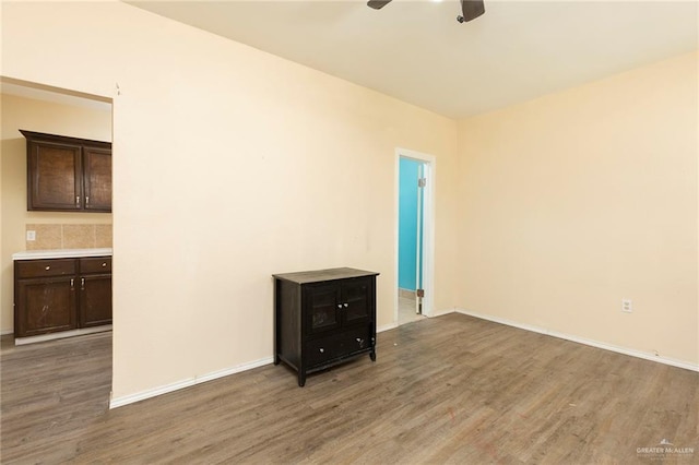 empty room with ceiling fan and dark wood-type flooring