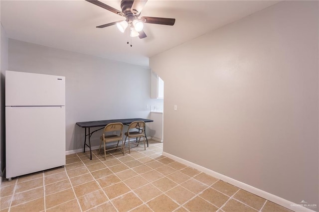 laundry room with ceiling fan and light tile patterned floors