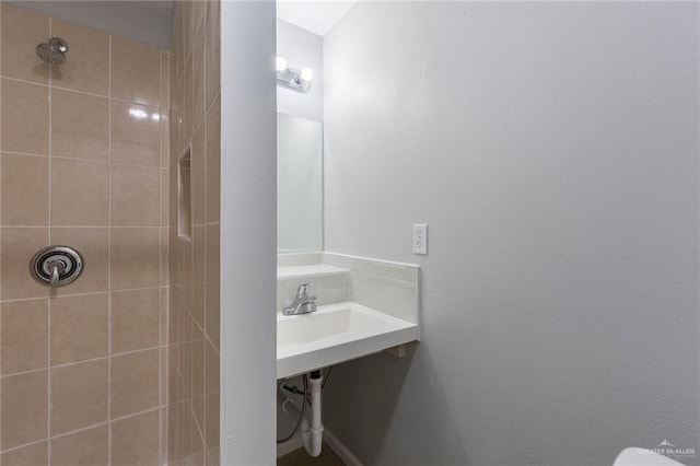 bathroom with a tile shower