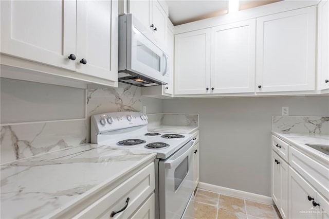 kitchen featuring white cabinetry, white appliances, and backsplash