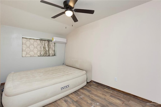 bedroom with dark hardwood / wood-style flooring, an AC wall unit, ceiling fan, and vaulted ceiling