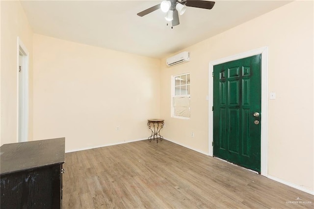 entrance foyer featuring hardwood / wood-style flooring, a wall mounted AC, and ceiling fan