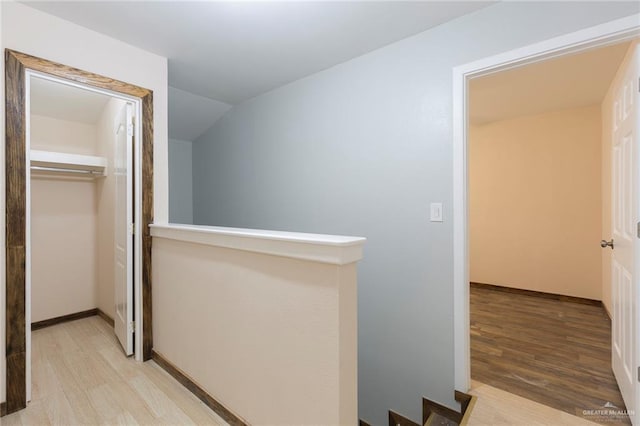 corridor with light hardwood / wood-style floors