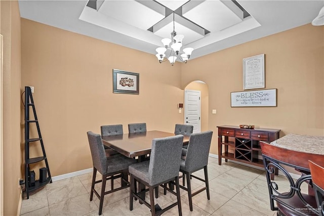 2504 April Ave, Edinburg, TX 78541 - dining area featuring arched walkways, light marble finish flooring, a chandelier, and a raised ceiling