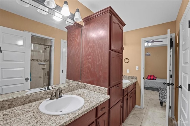 2504 April Ave, Edinburg, TX 78541 - bathroom with vanity, tiled shower, ensuite bathroom, ceiling fan, and marble look tile flooring