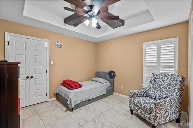 2504 April Ave, Edinburg, TX 78541 - bedroom with a raised ceiling, light marble finish flooring, and ceiling fan
