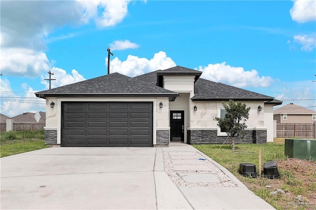 view of front of home with a garage and a front lawn