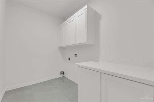 clothes washing area with cabinets and hookup for a washing machine