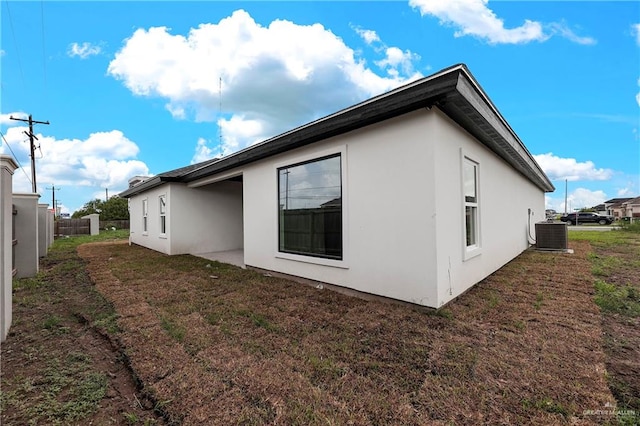 view of side of home featuring central AC unit