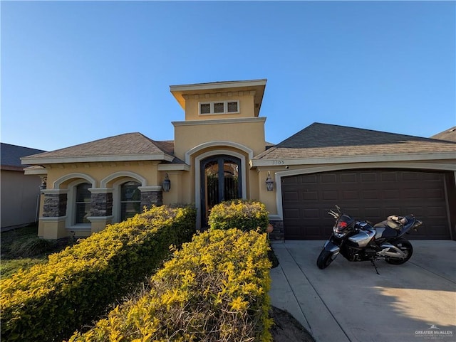 3300 Harding Ave, Alton, TX 78573 - mediterranean / spanish-style home featuring concrete driveway, an attached garage, stucco siding, and stone siding