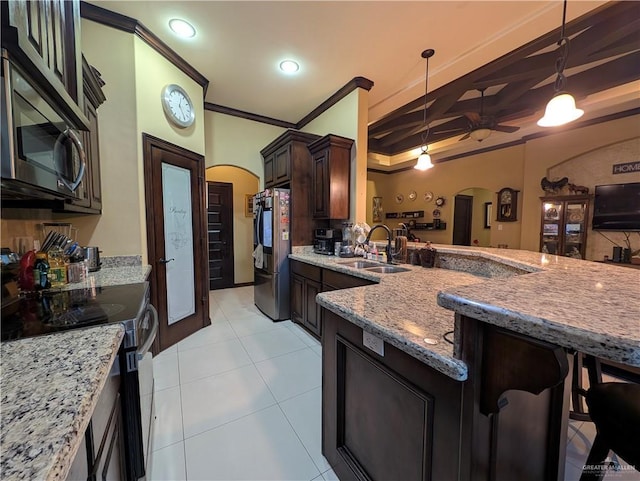 3300 Harding Ave, Alton, TX 78573 - kitchen with arched walkways, stainless steel appliances, a sink, ceiling fan, and light stone counters