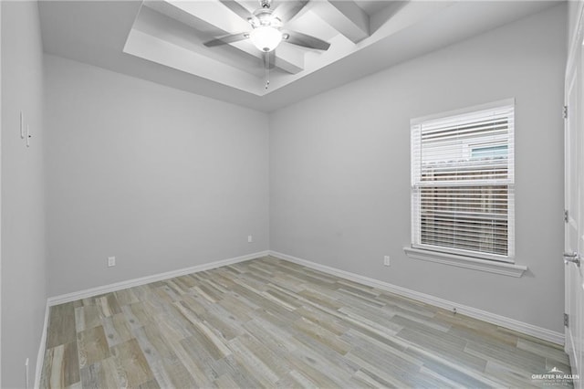 2008 Taft St, Weslaco, TX 78599 - unfurnished room featuring light wood-style flooring, ceiling fan, a tray ceiling, and baseboards