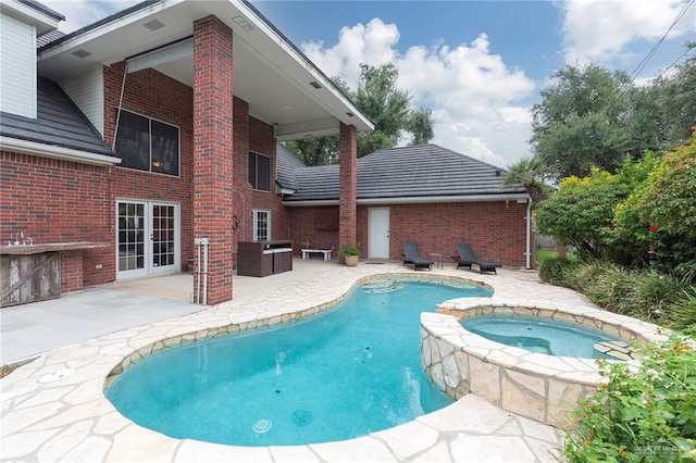 view of swimming pool with an in ground hot tub and a patio