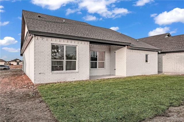 back of house featuring a patio and a lawn