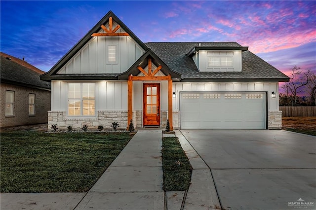 view of front facade with a garage and a lawn