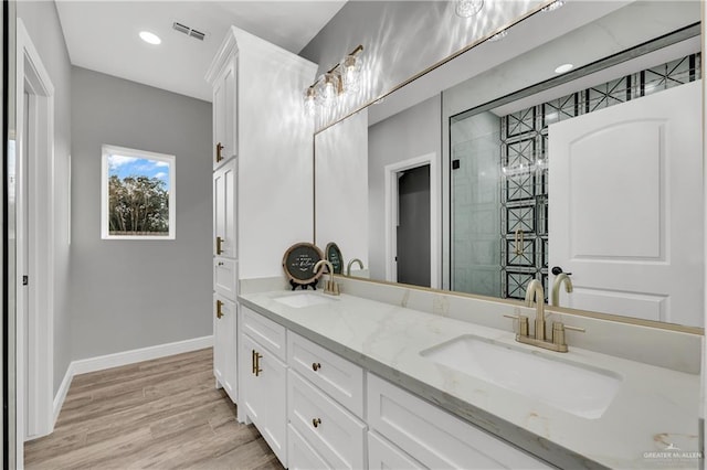 bathroom featuring hardwood / wood-style flooring and vanity