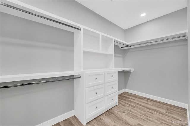 spacious closet with light hardwood / wood-style floors