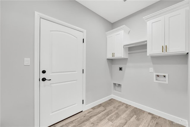 washroom with cabinets, hookup for an electric dryer, hookup for a washing machine, and light hardwood / wood-style flooring