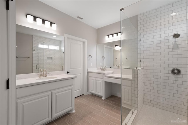 bathroom featuring vanity and a shower with shower door