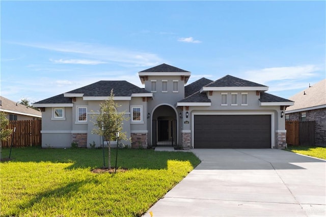 view of front of home with a garage and a front lawn