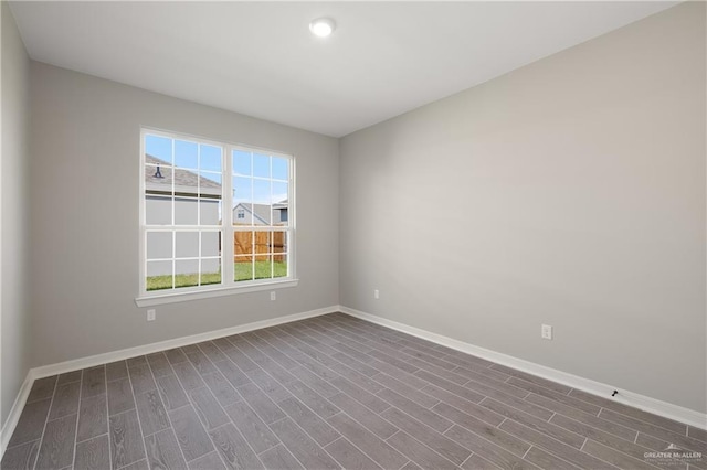 spare room featuring wood-type flooring