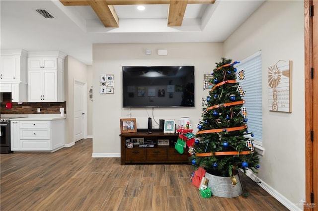 living room with beam ceiling, dark hardwood / wood-style flooring, and coffered ceiling