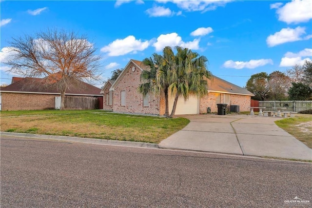 4405 W Ivy Ave, Mcallen, TX 78501 - view of front of property featuring driveway, central AC unit, brick siding, and a garage