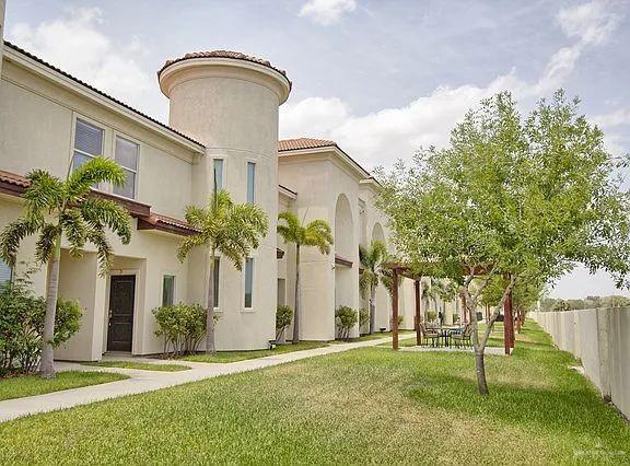 1413 E Keeton Ave Unit 19, Mcallen, TX 78503 - exterior space with a tile roof, fence, a front lawn, and stucco siding