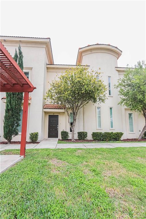 1413 E Keeton Ave Unit 19, Mcallen, TX 78503 - view of front of property featuring a front lawn, a pergola, and stucco siding