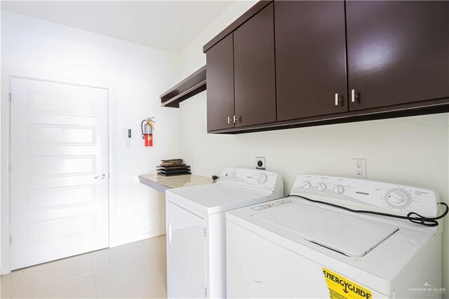 1413 E Keeton Ave Unit 19, Mcallen, TX 78503 - laundry area featuring cabinet space, washing machine and clothes dryer, and light tile patterned floors