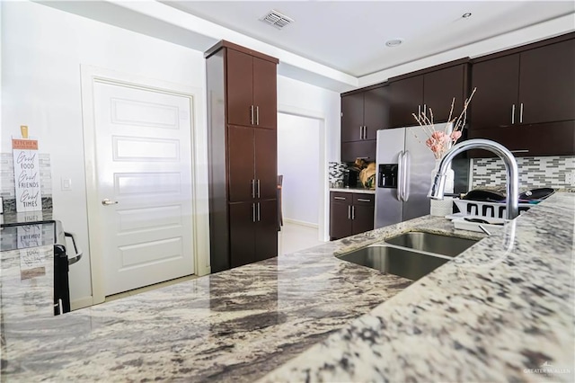 1413 E Keeton Ave Unit 19, Mcallen, TX 78503 - kitchen featuring visible vents, stainless steel fridge with ice dispenser, light stone counters, a sink, and backsplash