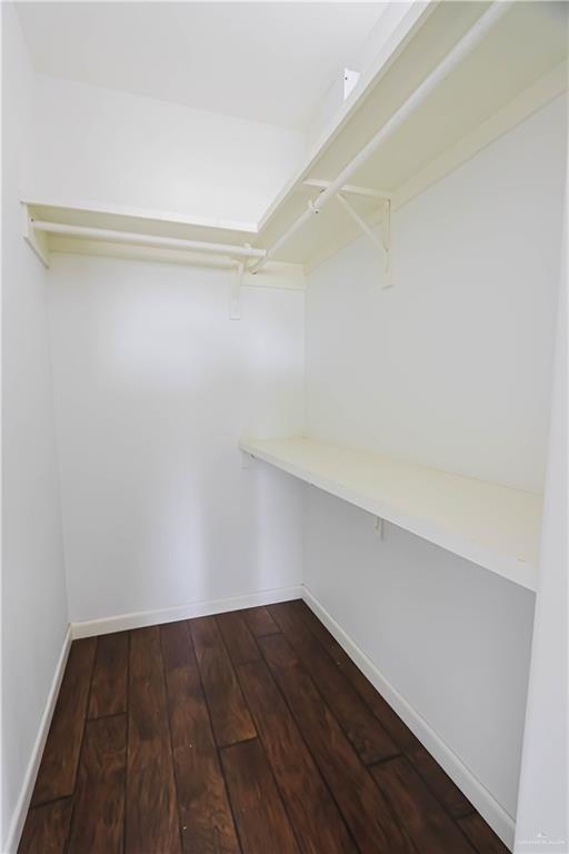 1413 E Keeton Ave Unit 19, Mcallen, TX 78503 - walk in closet featuring dark wood finished floors