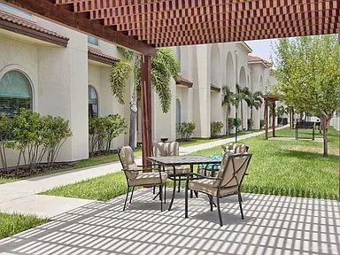 1413 E Keeton Ave Unit 19, Mcallen, TX 78503 - view of patio with outdoor dining area and a pergola