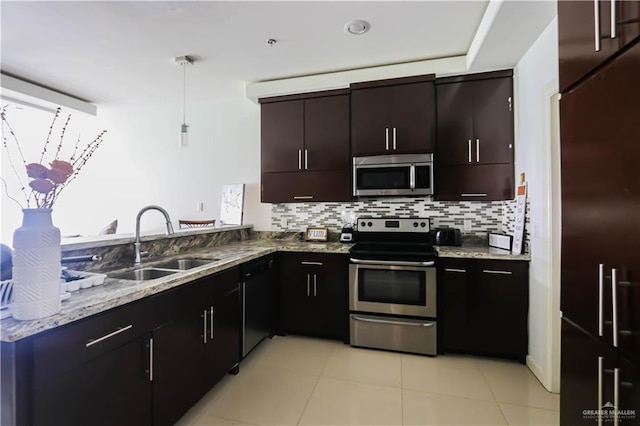 1413 E Keeton Ave Unit 19, Mcallen, TX 78503 - kitchen featuring light stone counters, stainless steel appliances, backsplash, a sink, and a peninsula